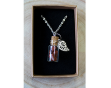 Load image into Gallery viewer, A boxed silver necklace with a leaf and small corked bottle of goldstone crystals.
